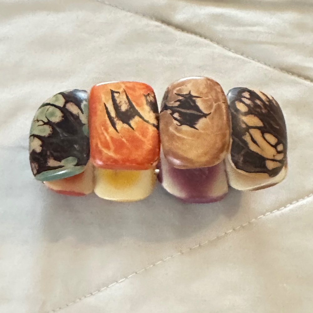 Tagua nut stretchy bracelet, about 7.5” long. Multicolor, carved